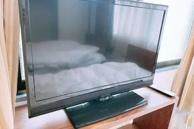 a flat screen tv sitting on top of a table at Esperanza 204\u53f7\u5ba4 in Tokyo
