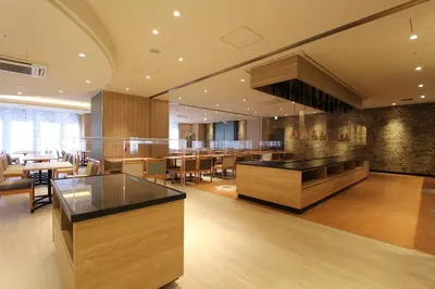 a restaurant with a bar and tables and chairs at KOKO HOTEL Tsukiji Ginza in Tokyo