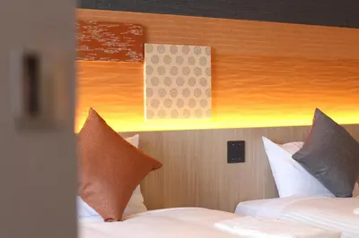 a hotel room with two beds with pillows at KOKO HOTEL Tsukiji Ginza in Tokyo