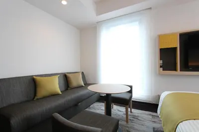 a living room with a couch and a table at KOKO HOTEL Tsukiji Ginza in Tokyo