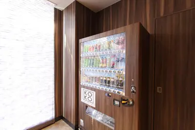a drink machine in a room with a window at KOKO HOTEL Tsukiji Ginza in Tokyo