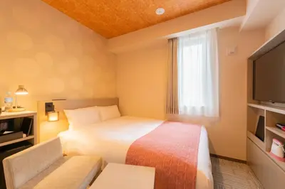 a hotel room with a bed and a television at Tosei Hotel Cocone Asakusa in Tokyo