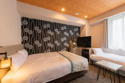 a hotel room with a bed and a tv at Tosei Hotel Cocone Asakusa in Tokyo
