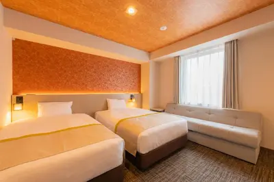 a hotel room with two beds and a window at Tosei Hotel Cocone Asakusa in Tokyo