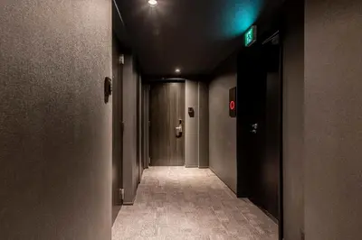 an empty hallway with a green light in a building at hotel aima in Tokyo