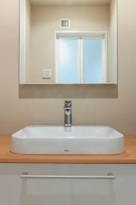a white sink in a bathroom under a mirror at hotel aima in Tokyo