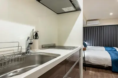 a kitchen with a sink and a bed in a room at hotel aima in Tokyo