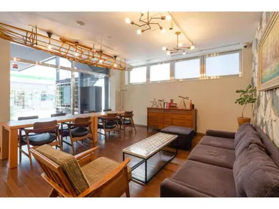 a living room with a couch and a table and chairs at Hotel Emit Shibuya - Vacation STAY 40890v in Tokyo