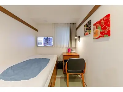 a bedroom with a bed and a desk and a chair at Hotel Emit Shibuya - Vacation STAY 40888v in Tokyo