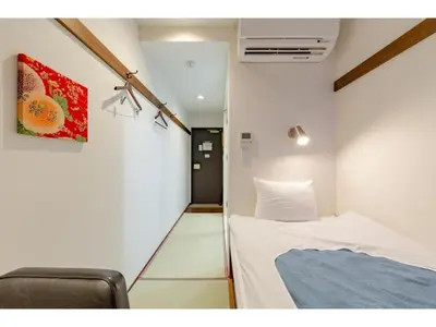 a small room with a bed and a chair at Hotel Emit Shibuya - Vacation STAY 40888v in Tokyo