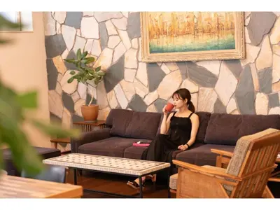 a woman sitting on a couch talking on a phone at Hotel Emit Shibuya - Vacation STAY 40892v in Tokyo