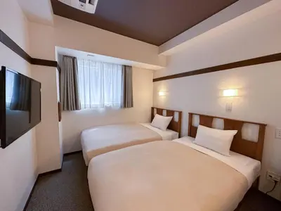 a hotel room with two beds and a flat screen tv at Hotel Emit Shibuya - Vacation STAY 40894v in Tokyo