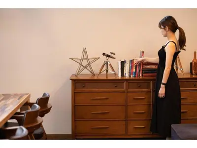 a woman in a black dress standing next to a dresser at Hotel Emit Shibuya - Vacation STAY 40894v in Tokyo