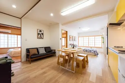 a kitchen and living room with a table and a couch at \u5bc5\u30db\u30c6\u30eb \u53f0\u6771 Hotel \u5bc5 \u53f0\u4e1c Tora Hotel Taito D in Tokyo