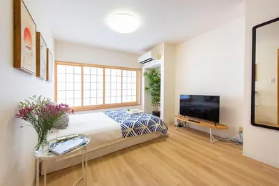 a bedroom with a bed and a flat screen tv at \u5bc5\u30db\u30c6\u30eb \u53f0\u6771 Hotel \u5bc5 \u53f0\u4e1c Tora Hotel Taito D in Tokyo