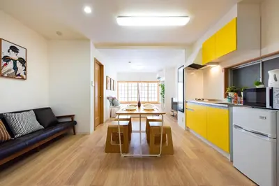 a kitchen and living room with a table and a couch at \u5bc5\u30db\u30c6\u30eb \u53f0\u6771 Hotel \u5bc5 \u53f0\u4e1c Tora Hotel Taito D in Tokyo