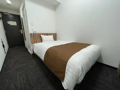 a bedroom with a large bed in a room at Ueno Urban Hotel Annex in Tokyo