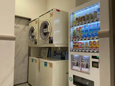 a laundry room with a washer and dryer at Ueno Urban Hotel Annex in Tokyo