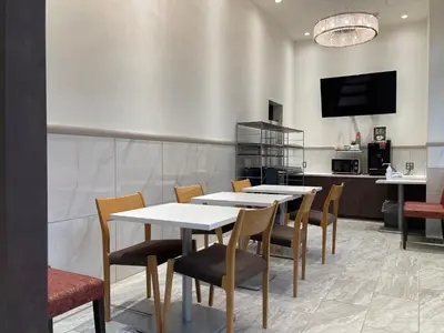 a dining room with white tables and chairs at Ueno Urban Hotel Annex in Tokyo