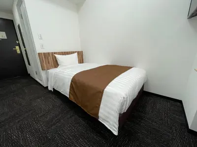 a bedroom with a large bed in a room at Ueno Urban Hotel Annex in Tokyo