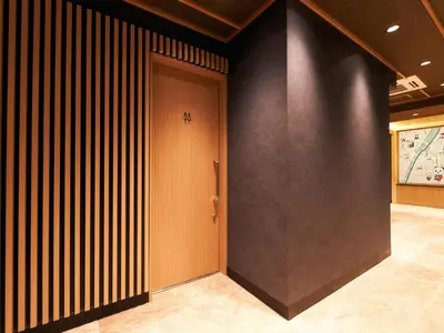 a hallway with a wooden door in a building at Rakuten STAY Tokyo Asakusa Twin Room in Tokyo