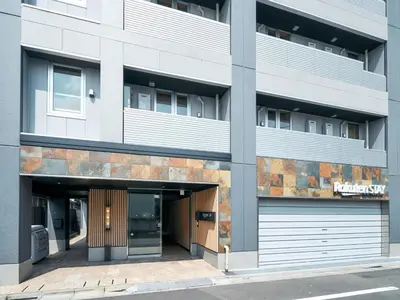 an apartment building with a parking garage at Rakuten STAY Tokyo Asakusa Twin Room in Tokyo