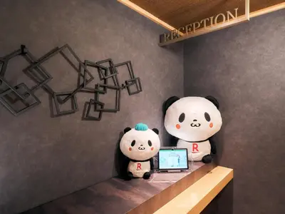 two stuffed pandas sitting on a shelf with a laptop at Rakuten STAY Tokyo Asakusa Okaimono Panda Double Room in Tokyo