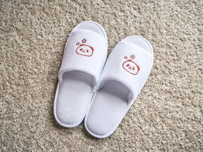 a pair of white slippers with faces on them at Rakuten STAY Tokyo Asakusa Okaimono Panda Twin Room A in Tokyo