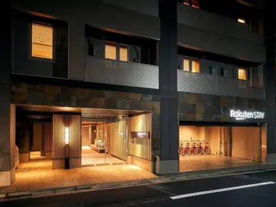 a building with doors open on a street at night at Rakuten STAY Tokyo Asakusa Okaimono Panda Twin Room A in Tokyo