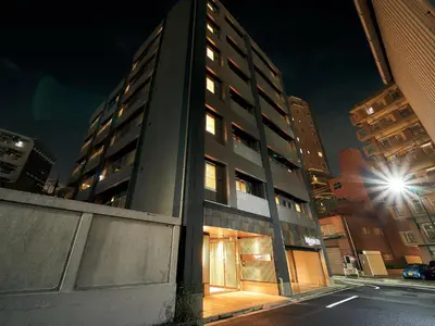a tall building with its doors lit up at night at Rakuten STAY Tokyo Asakusa 1 Double Bed Room in Tokyo