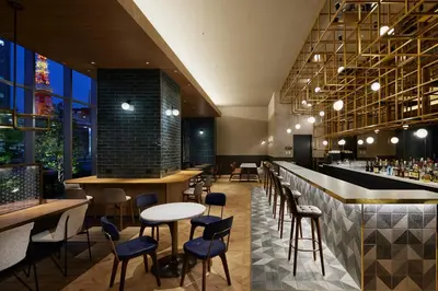 a restaurant with tables and chairs and a bar at Oakwood Hotel & Apartments Azabu Tokyo in Tokyo