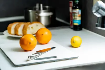 a counter with oranges and a knife and a plate of bread at Oakwood Hotel & Apartments Azabu Tokyo in Tokyo
