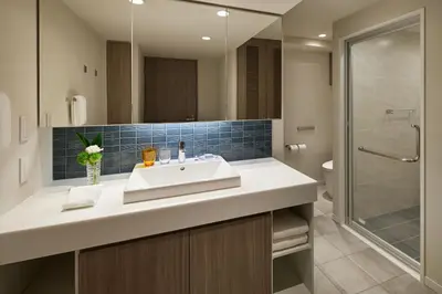 a bathroom with a sink and a shower at Oakwood Hotel & Apartments Azabu Tokyo in Tokyo