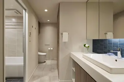 a bathroom with a sink and a toilet and a tub at Oakwood Hotel & Apartments Azabu Tokyo in Tokyo