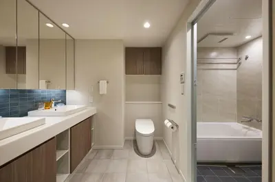 a bathroom with a toilet and a sink and a tub at Oakwood Hotel & Apartments Azabu Tokyo in Tokyo