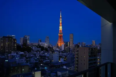 a view of the eiffel tower at night at Oakwood Hotel & Apartments Azabu Tokyo in Tokyo