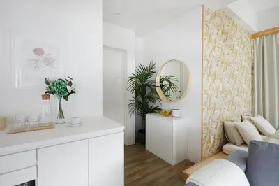a white living room with a mirror and a couch at Designers Hotel Siesta in Tokyo