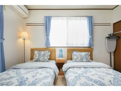 two beds in a small room with a window at La Mer Urayasu - Vacation STAY 11148 in Urayasu