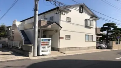 a white house with a car parked in front of it at La Mer Urayasu - Vacation STAY 11148 in Urayasu