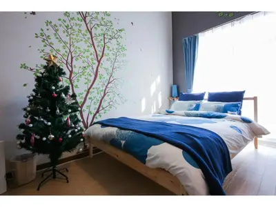 a bedroom with a christmas tree next to a bed at Maison Cresta Urayasu - Vacation STAY 11150 in Urayasu