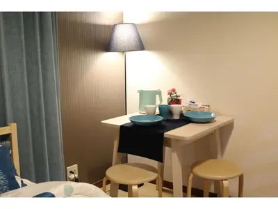 a small table with two chairs and a lamp at Maison Cresta Urayasu - Vacation STAY 11150 in Urayasu
