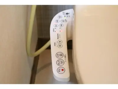 a white remote control sitting next to a toilet at Maison Cresta Urayasu - Vacation STAY 11150 in Urayasu