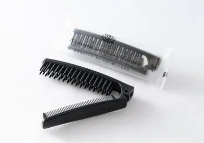 a black comb and a white package of hairbrush at APA Hotel Asakusa Kaminarimon Minami in Tokyo