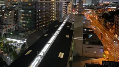 a train on top of a building in a city at Toyoko Inn Tokyo Shinagawa Aomono-yokocho-eki in Tokyo