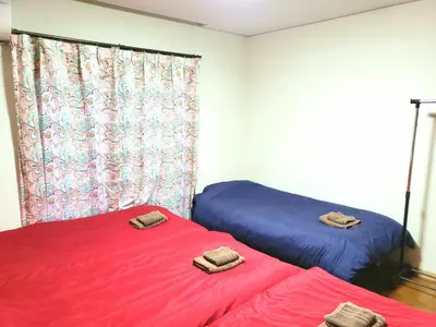 two beds sitting next to each other in a room at Within walking distance of Disneyland! - Vacation STAY 11473 in Urayasu