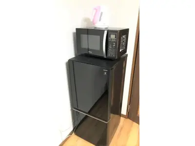 a microwave oven sitting on top of a black stand at Central Field - Vacation STAY 29627v in Tokyo