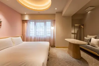 a bedroom with a bed and a table and a window at hotel hisoca ikebukuro in Tokyo