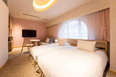 a hotel room with two beds and a tv at hotel hisoca ikebukuro in Tokyo