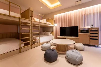 a room with two bunk beds and a tv at hotel hisoca ikebukuro in Tokyo