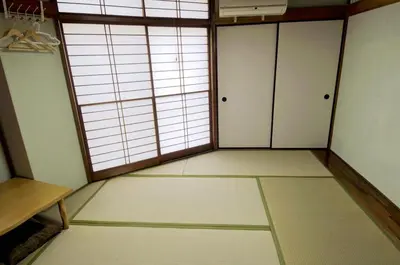 an empty room with a large window and white floors at \u6b66\u8535Musashi Hotel in Tokyo